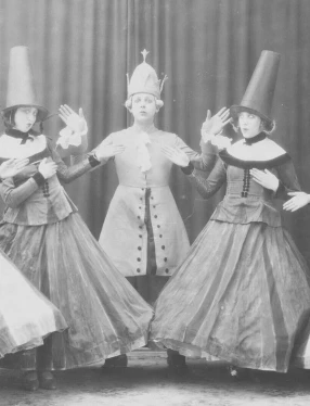 Ett svartvitt fotografi av fem dansare från Svenska Baletten i Paris under 1920-talet, i uppsättningen "De fåvitska jungfrurna". Till höger ligger ett tjockt streck i hallonrött.